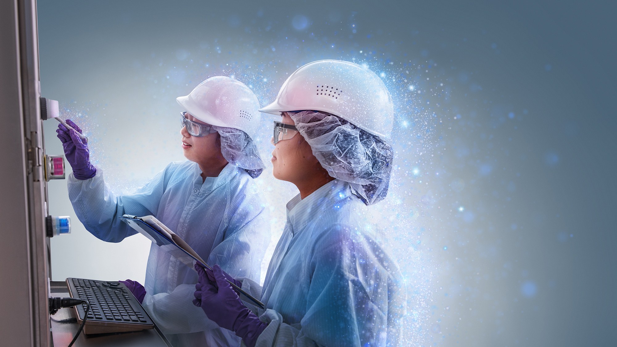 Two technicians in cleanroom garments and hard hats at an ultrafiltration unit